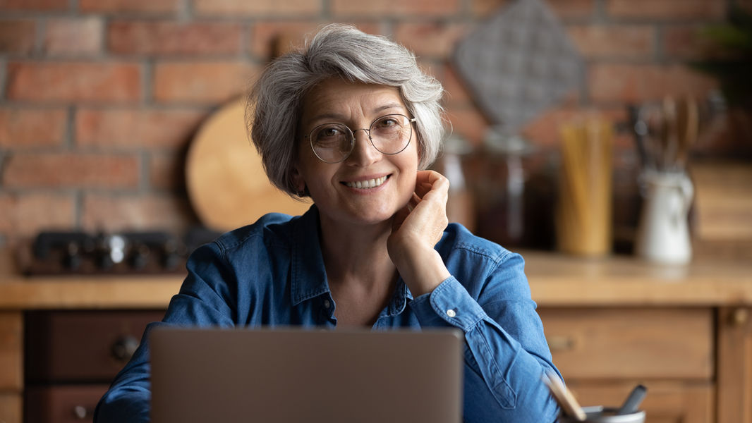 Person smiling with a laptop