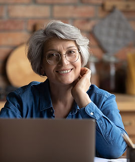 Person smiling with a laptop