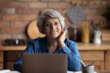 Person smiling with a laptop