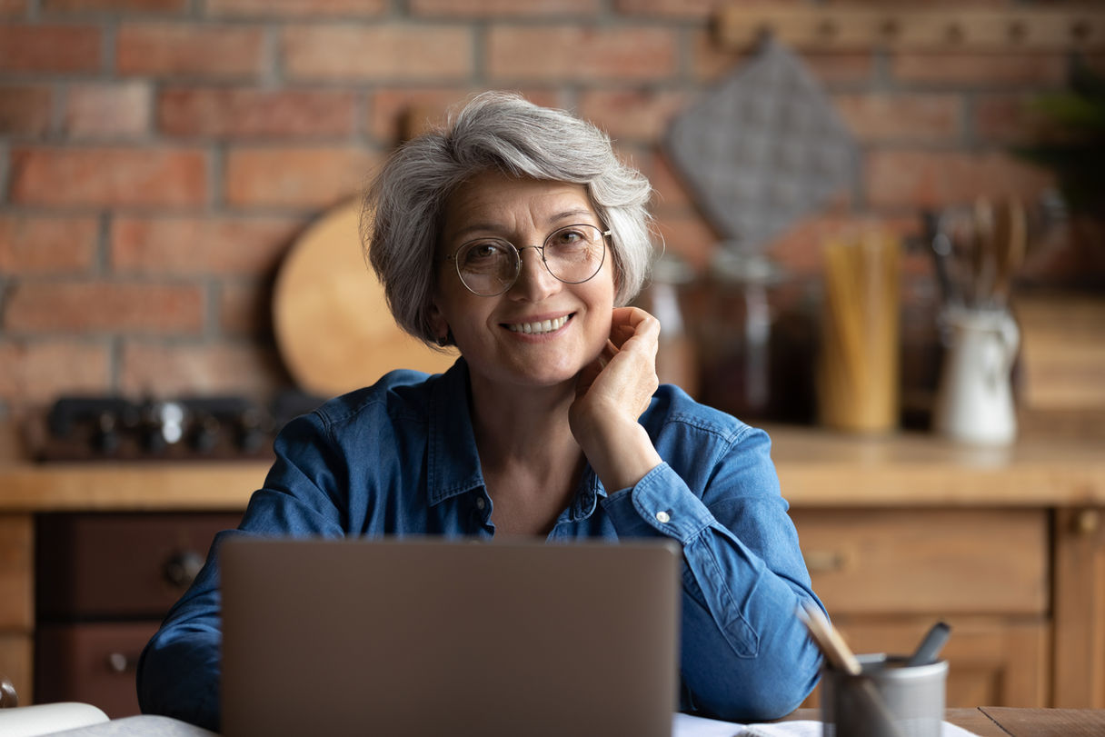 Person smiling with a laptop