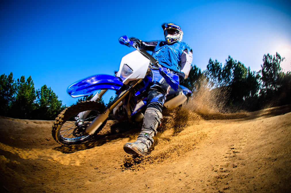 Enduro bike rider on action. Turn on sand terrain