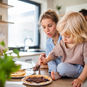 child sitting with family playing with food instead of eating it