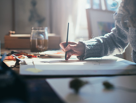 Artist Sketching at Desk