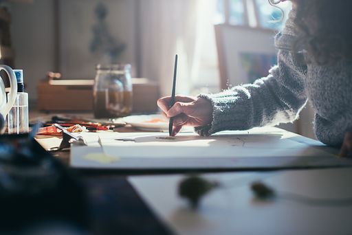 Artist Sketching at Desk