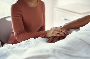 a carer holding hand of an elder person