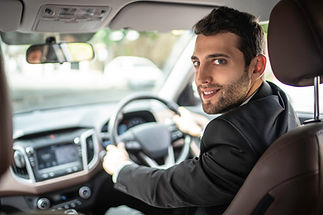 Man inside a car and looking back