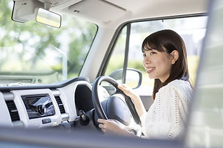 a smiling woman driver inside a car