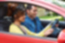 Young Woman Having Driving Lesson With Instructor