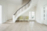 White hallway with elegant staircase