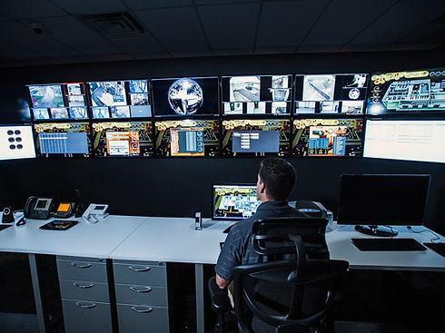 security guard watching monitors in control room