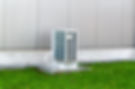 Air source unit fitted outside modern home for heat pump servicing.