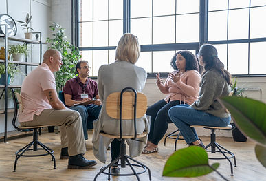 Group of individuals engaged in a wellness workshop focused on mental health and self-care strategies.