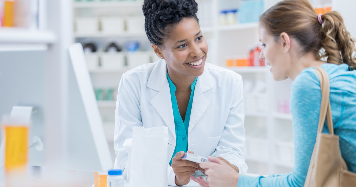 A pharmacist discussing different types of pain medicines with a patient to support safe and effective pain management.