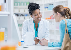 A pharmacist discussing different types of pain medicines with a patient to support safe and effective pain management.