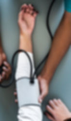 close up of a doctor taking someone's blood pressure with a cuff
