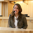 Woman Speaking at Microphone