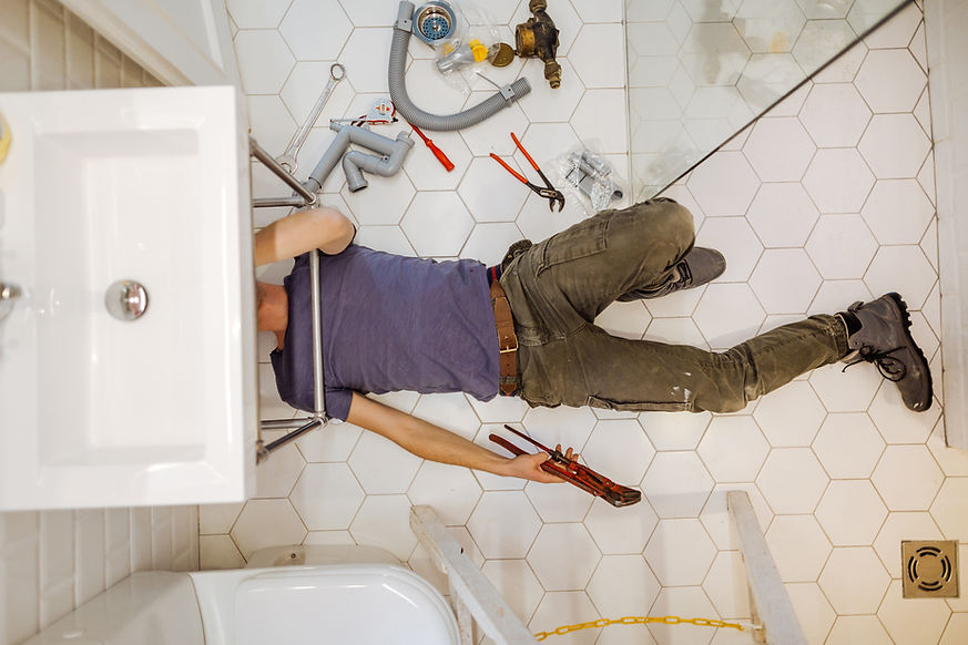 Man solving plumbing problems in his bathroom