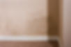 Textured interior wall showing extensive dampness and black mould patches needing treatment