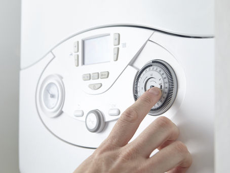 A Woman turning the radiator knob