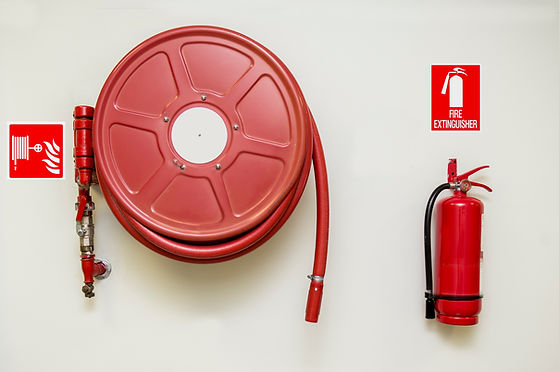 Fire hose reel and fire extinguisher with signs
