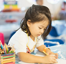 Kid Drawing With Colored Pencil