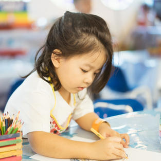 Kid Drawing With Colored Pencil