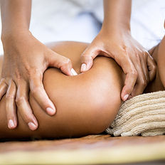Woman has her shoulder massaged using Emmett Techniques