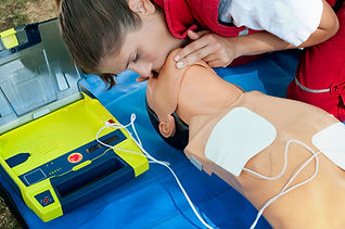 A woman performs CPR on a training mannequin