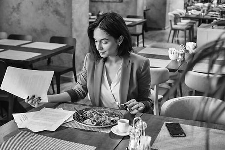 Businesswoman reviewing analytics at a restaurant.