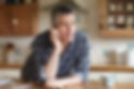 Man using phone in kitchen