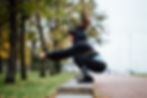 A woman doing outdoor exercise park. She is performing wall jumps as part of an outdoor strength training program.