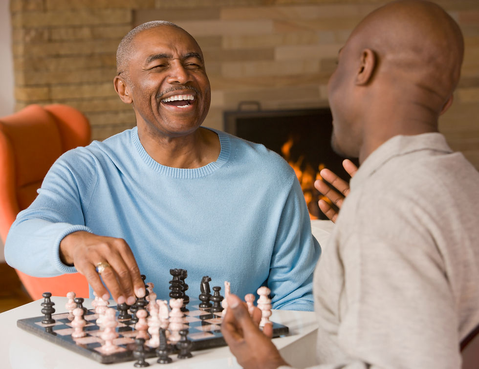 Chess Game Interaction, 2 men laughing while playing chess