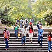 Students on a campus walking down an outdoor staircase