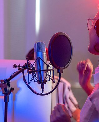 A woman singing in a record studio