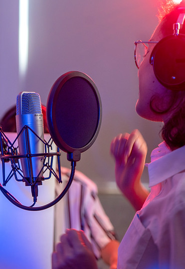 A woman singing in a record studio
