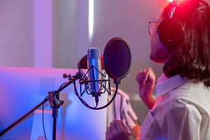 A woman singing in a record studio