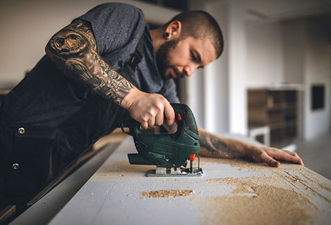 Image of a man cutting Wood representing that disability awareness training can apply to all trades and workplaces.