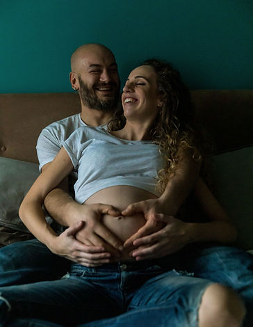 expectant parents, holding preganacy baby bump