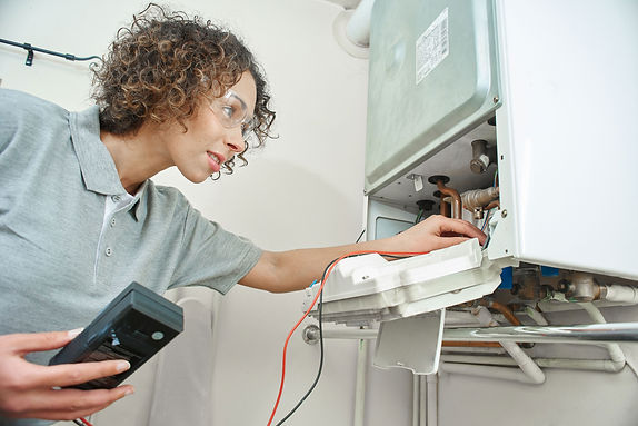 Technician Repairing Boiler