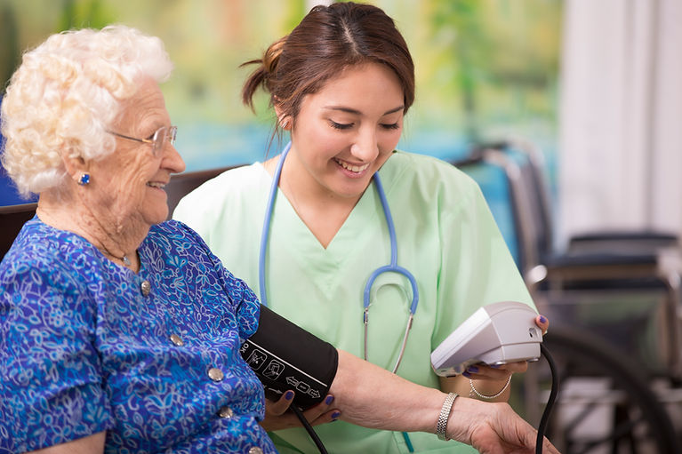 Close-up of a senior individual resting their hands comfortably while receiving care at home