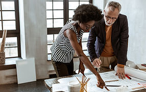 A Man and a Woman looking at a Design