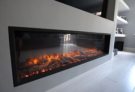 A large electric flame effect fire with logs and pebbles in a lounge with vinyl flooring