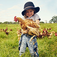 Adorable Kid Holding Chicken