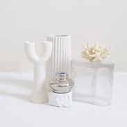 A collection of white knick-knacks arranged in a pleasing manner.