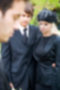 Mourners in black at a funeral