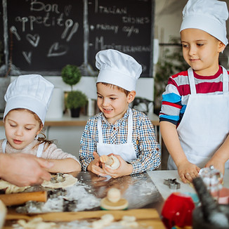 Nanny cooking with children in Surrey