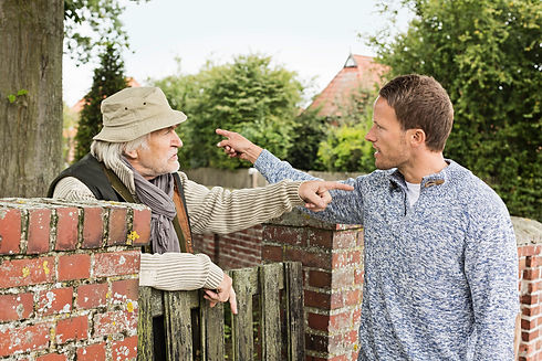 Senior man and mid adult man arguing