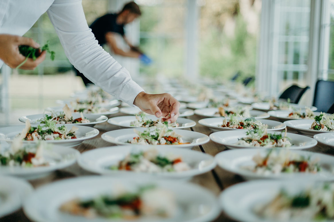 a person Plating the food at an event