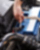 Close up of fitting a battery to a car in a garage
