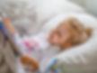 Little Girl Reading in Bed